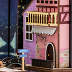 Colmar half-timbered house facade with balcony and riverside street sign in a miniature Alsace book nook insert