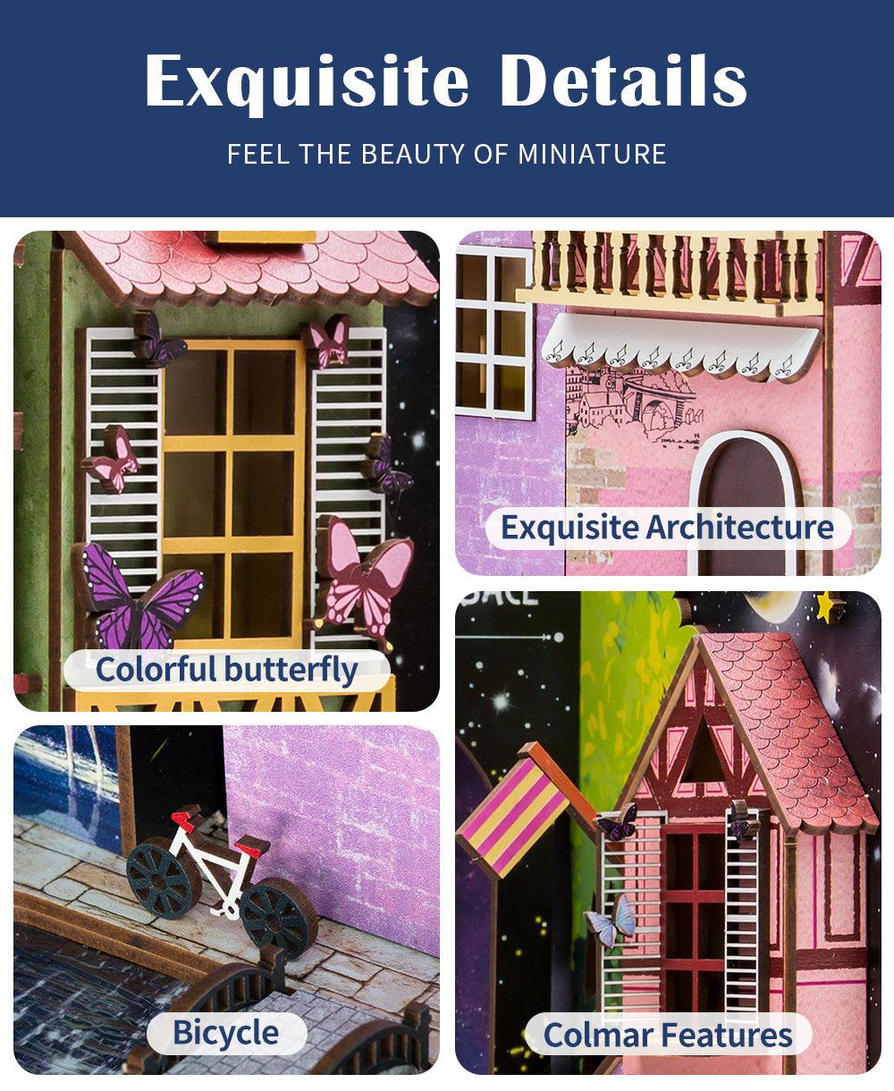 Hand-built Colmar diorama with a bicycle, timber-framed houses and fine miniature architecture in a DIY book nook kit