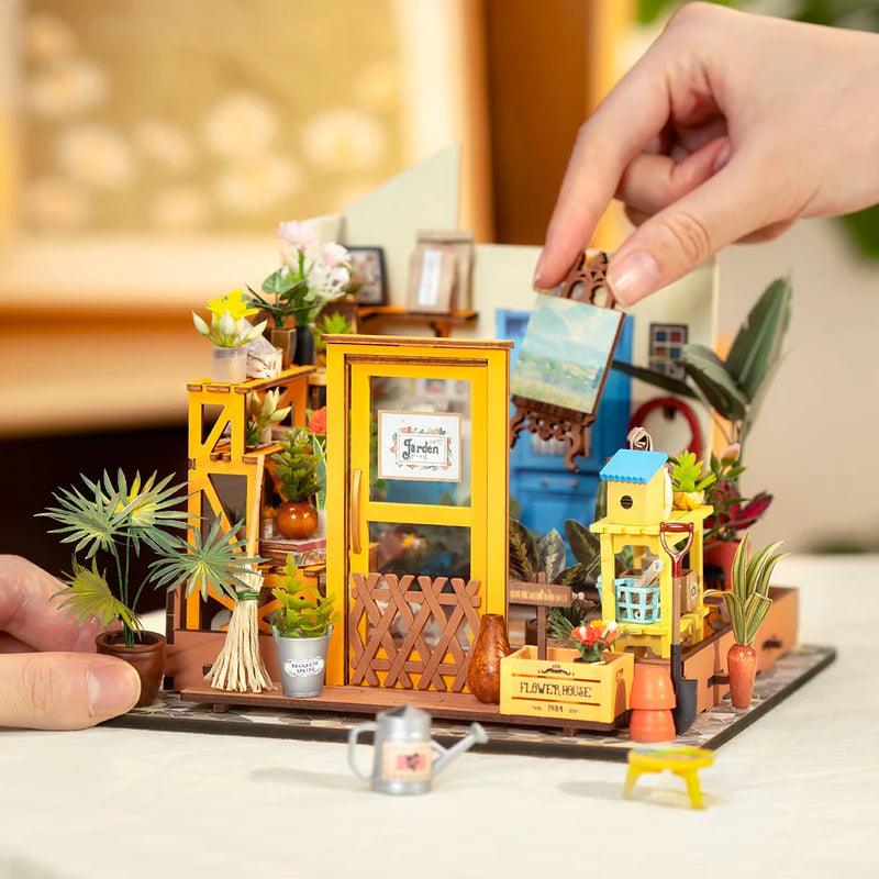 Miniature botanical greenhouse with built-in warm LED lighting for a glowing evening desk display and a cozy lit shelf scene