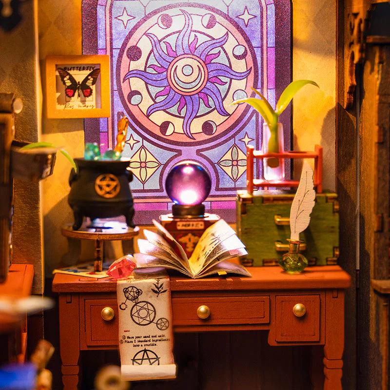 Handcrafted wizard room dollhouse with chair, shelving and mystical props, 1:18 scale build for fantasy readers and crafters