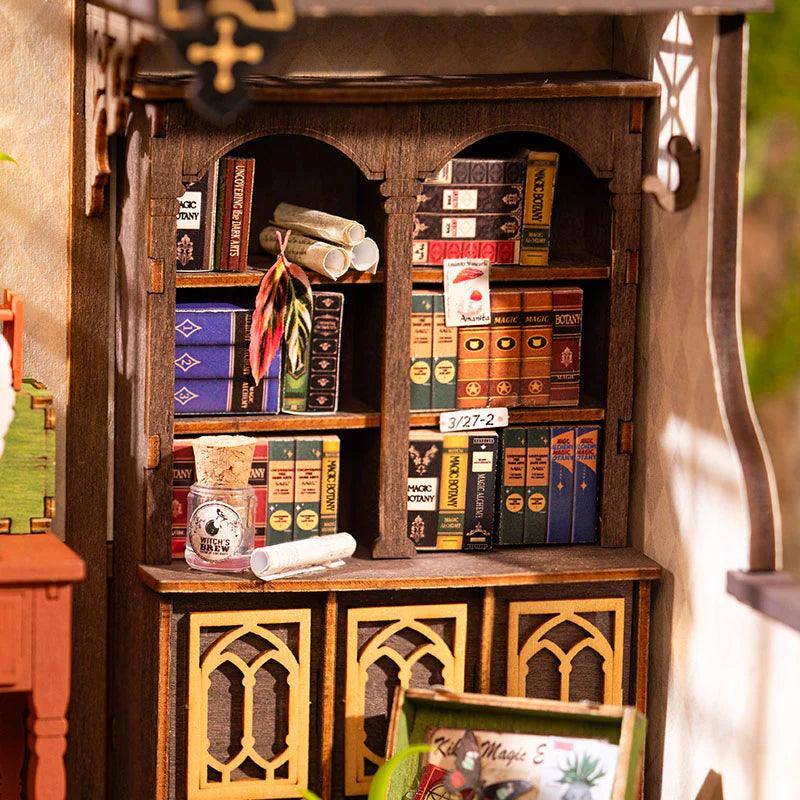 Illuminated wizard study miniature glowing after dark with warm lamp light, fantasy room build for shelf and desk decor