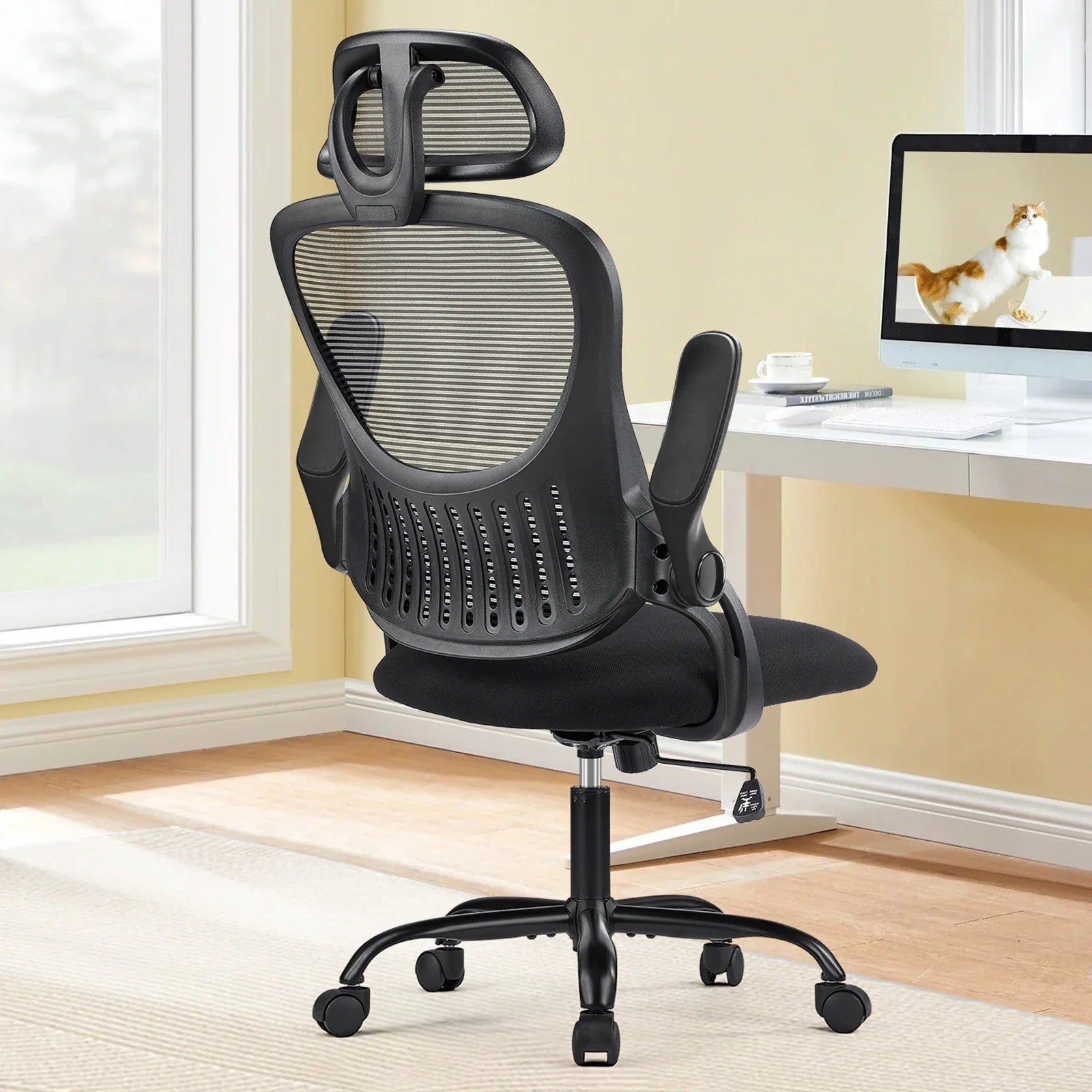 High back ergonomic office chair with lumbar support and padded flip-up armrests for long work hours at a computer desk, Black