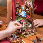 Miniature Wonderland diorama book nook with a gravity defying tea party scene and detailed storybook scenery for shelves