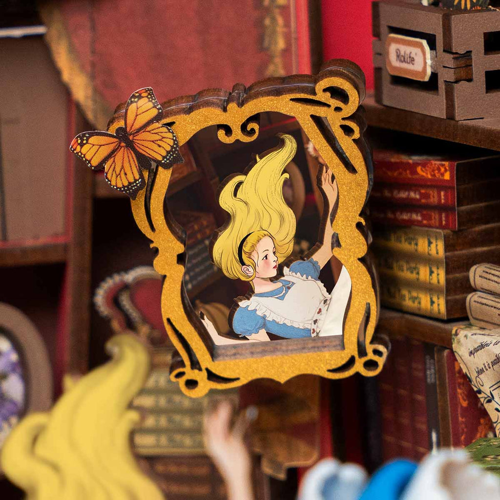 Lit miniature book nook that slots between books as a glowing reading nook accent and whimsical desk display piece