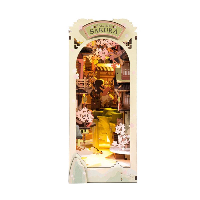 Japanese cherry blossom book nook kit with a warm LED river and pagodas, a lit bookshelf diorama for booklovers