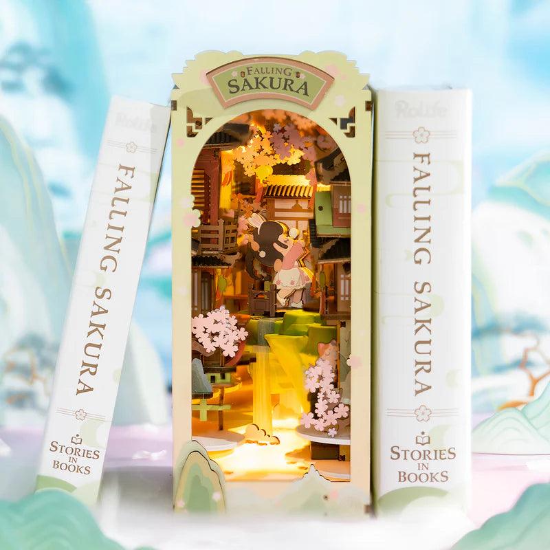 Illuminated sakura book nook that slots between books on a shelf, a Japanese diorama gift for readers and crafters
