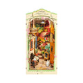 Floral corner book nook kit that builds a lit miniature flower shop between your books, a warm LED diorama for readers