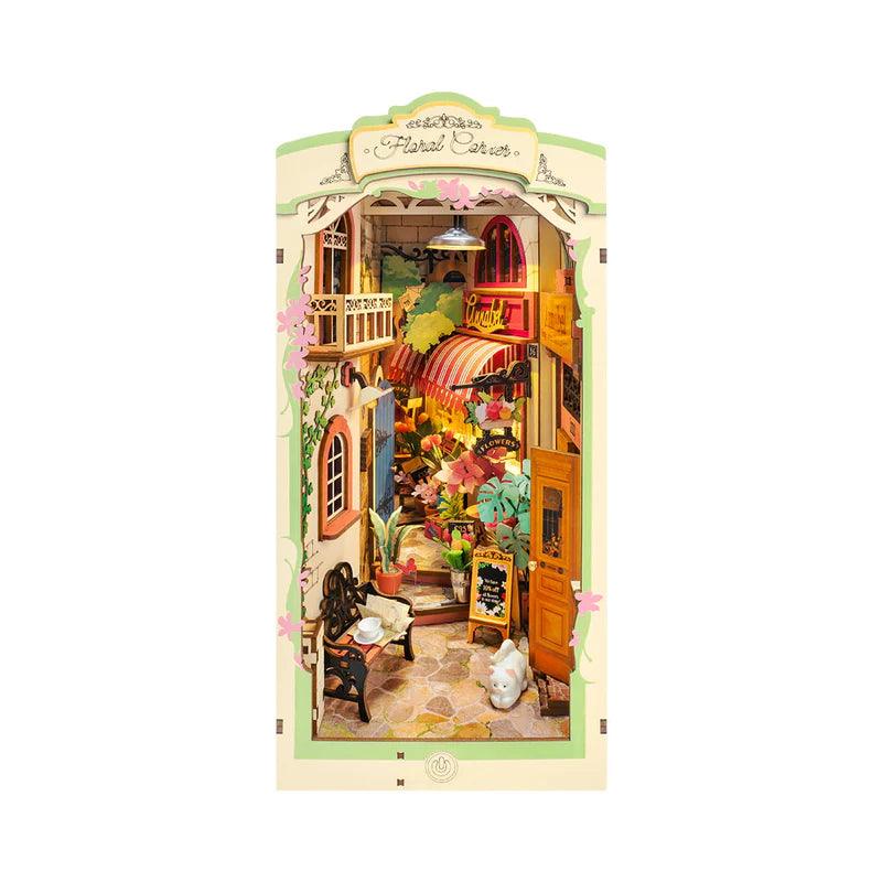 Floral corner book nook kit that builds a lit miniature flower shop between your books, a warm LED diorama for readers