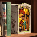 Warm LED floral corner book nook glowing on a bookshelf, a miniature flower boutique gift for gardeners and readers