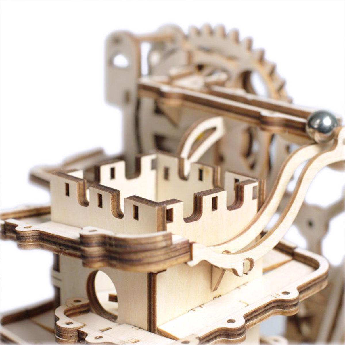 Castle style battlement towers guide marbles along the track, a mechanical wooden puzzle with a fortress inspired build