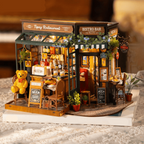Snap fit miniature dollhouse kit that assembles a lit French cafe in about five hours as a hands on crafting project