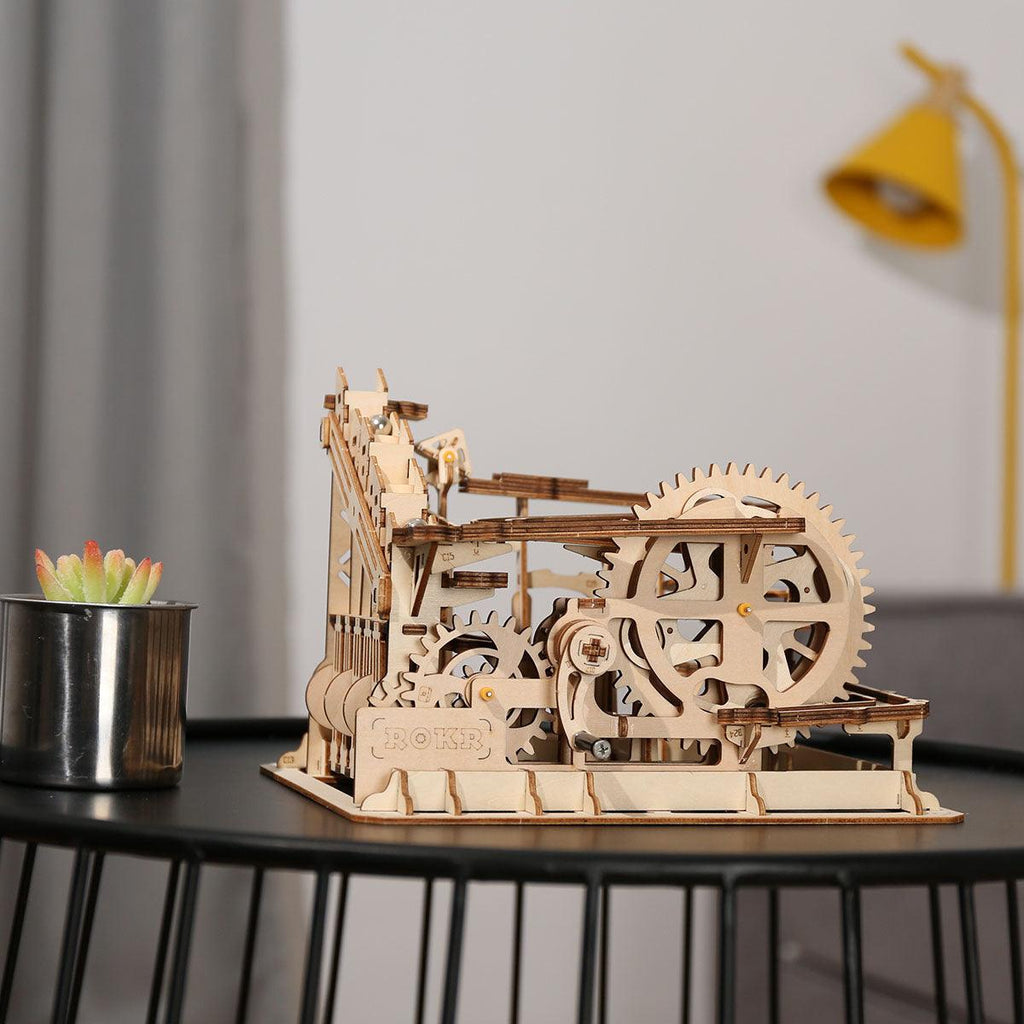 Assembled wooden marble run displayed as kinetic desk decor, a screen-free 3D puzzle gift idea for hobbyists and makers