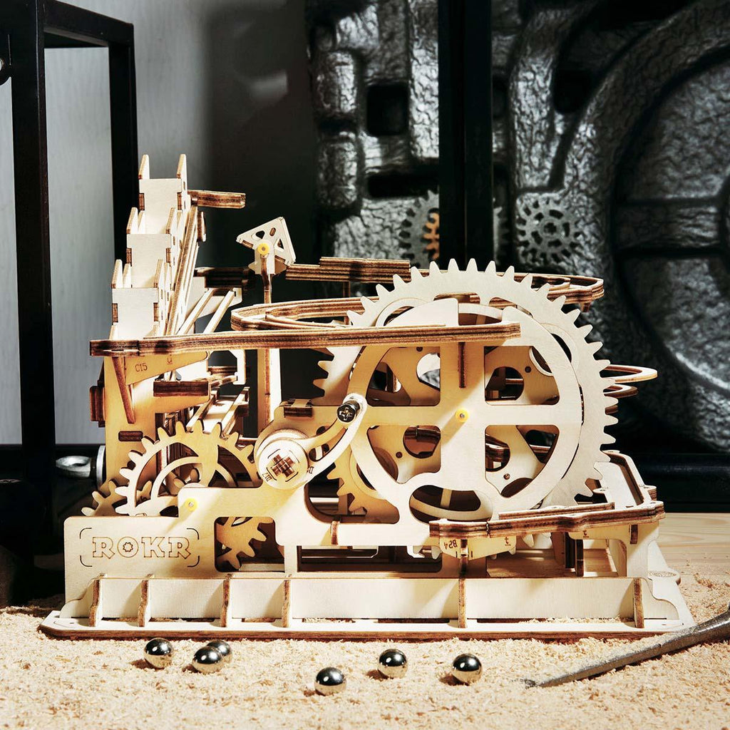 Marble run puzzle build in progress on a workbench, a 233 piece laser-cut wooden model kit for relaxing hobby assembly