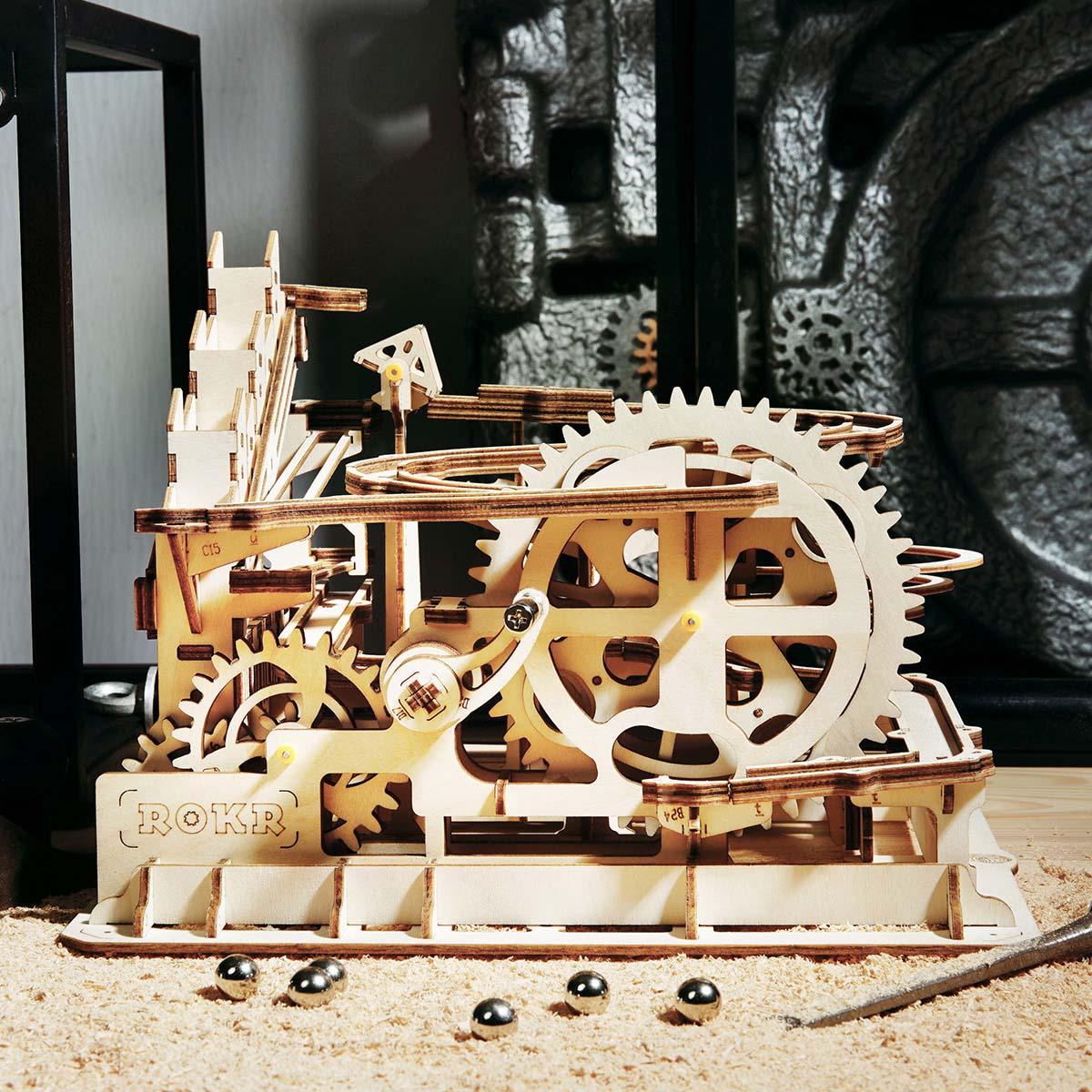 Marble run puzzle build in progress on a workbench, a 233 piece laser-cut wooden model kit for relaxing hobby assembly