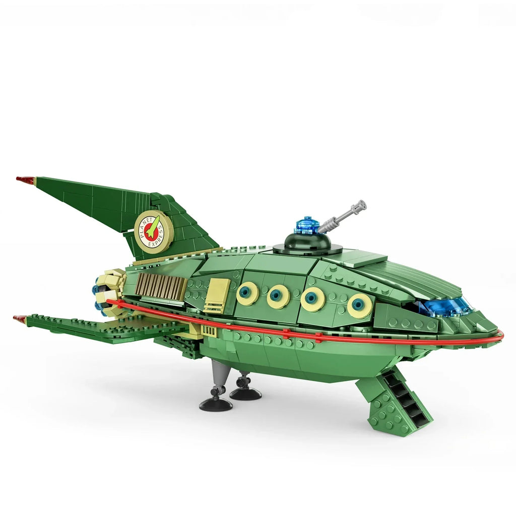 Green sci-fi spaceship model with swept wings and a blue cockpit dome, a finished starship display piece for hobby builders
