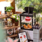 Warm LED lit garden cafe dollhouse for evening display, a cozy miniature model house for adult craft hobbyists