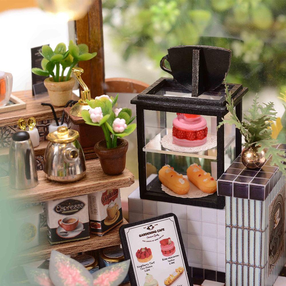 Warm LED lit garden cafe dollhouse for evening display, a cozy miniature model house for adult craft hobbyists