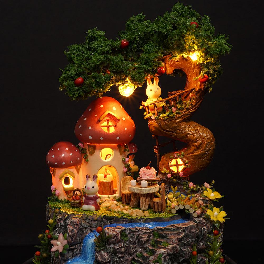Illuminated woodland fairy house scene with mushroom cottages, treehouse and waterfall, a glowing miniature diorama for adults