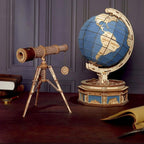 Two model wooden globe and telescope kit displayed in a study, a hands on astronomy and engineering build for teens
