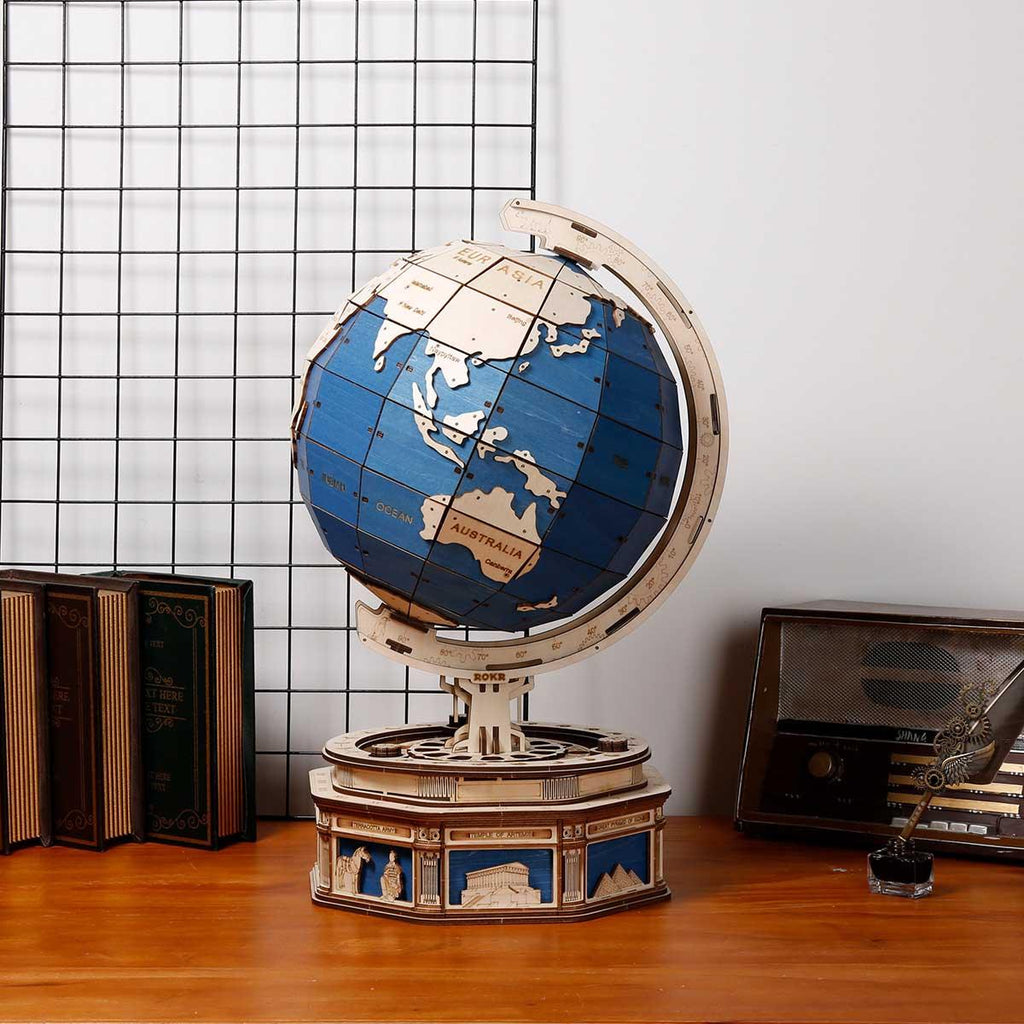 Rotating wooden desk globe with a secret constellation drawer and carved landmark base for geography and STEM fans