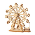 Wooden ferris wheel model kit with heart cutout gondolas and a park bench scene, a rotating 3D puzzle for shelf display