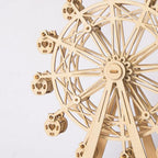 Intricate spoke wheel and heart shaped cabins on a wooden ferris wheel, a laser-cut model kit for patient hobby builders