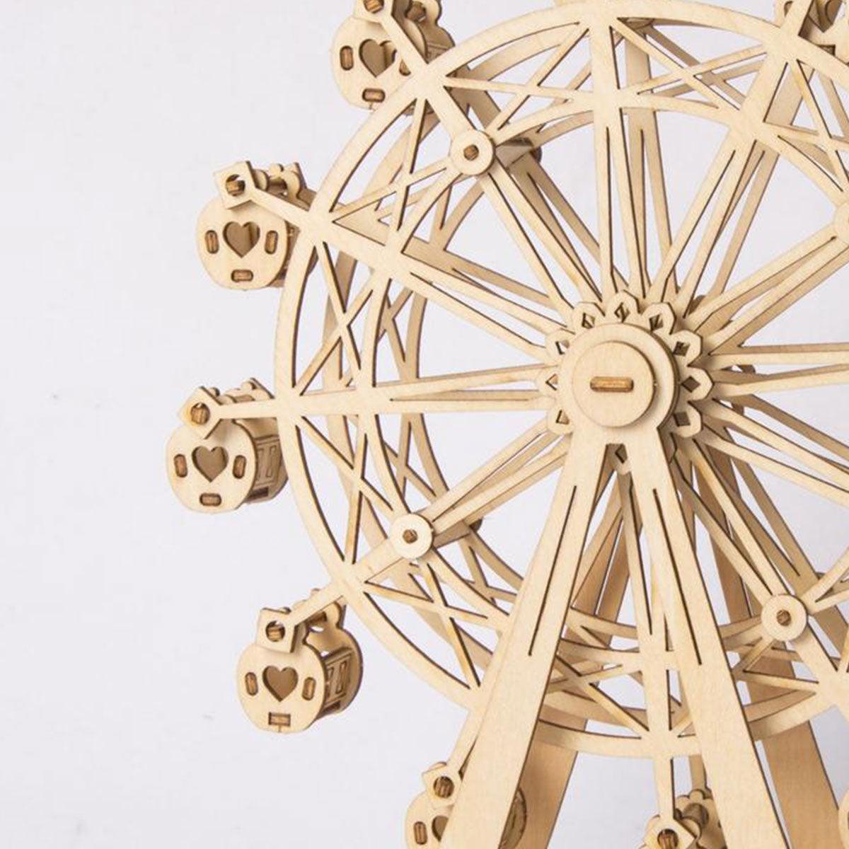 Intricate spoke wheel and heart shaped cabins on a wooden ferris wheel, a laser-cut model kit for patient hobby builders