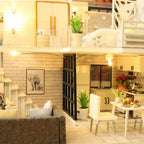Dollhouse living room and kitchen with a gray sofa, brick wall art and a fully fitted stove, a miniature house kit for adults