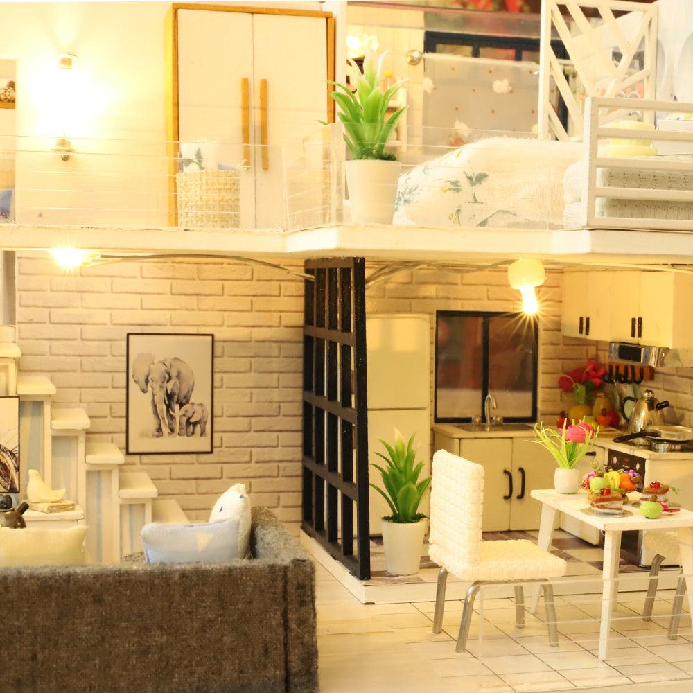 Dollhouse living room and kitchen with a gray sofa, brick wall art and a fully fitted stove, a miniature house kit for adults