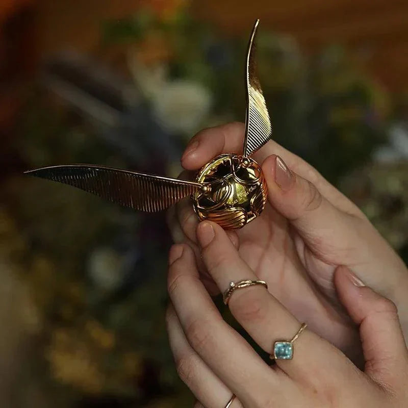 Gold plated snitch jewelry box opening to reveal the ring compartment, a wizarding world proposal gift for Potterheads RNGBX1