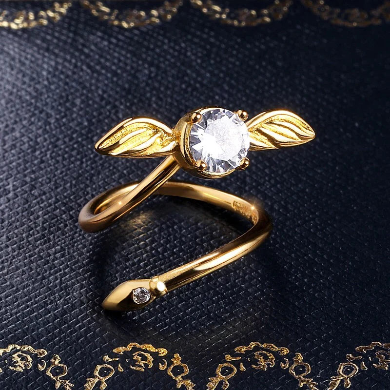 Adjustable Golden Snitch ring with a winged design and a clear stone, an included Harry Potter jewelry gift for fans RNGBX1