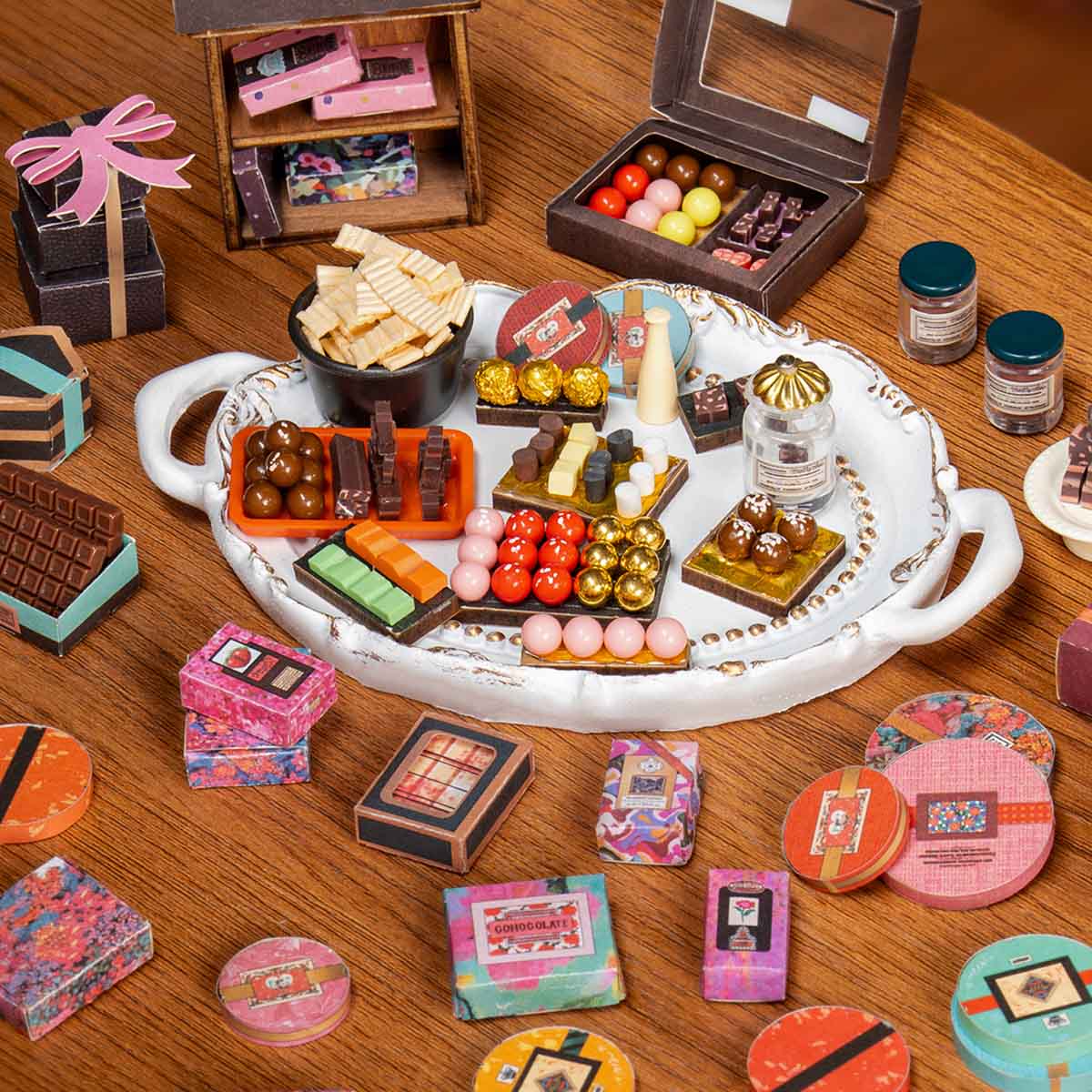Tray of tiny chocolates, truffles and bonbons from a DIY miniature chocolate shop kit, a crafting gift for miniature collectors