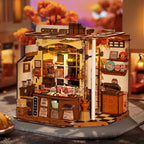 Miniature chocolate shop kit glowing with warm LED lights at dusk, a cozy display piece for a shelf or desk and a gift for adults
