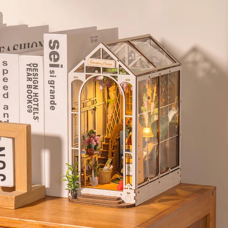 Miniature diorama craft gift for adults and book lovers who enjoy building lit garden scenes for their shelves
