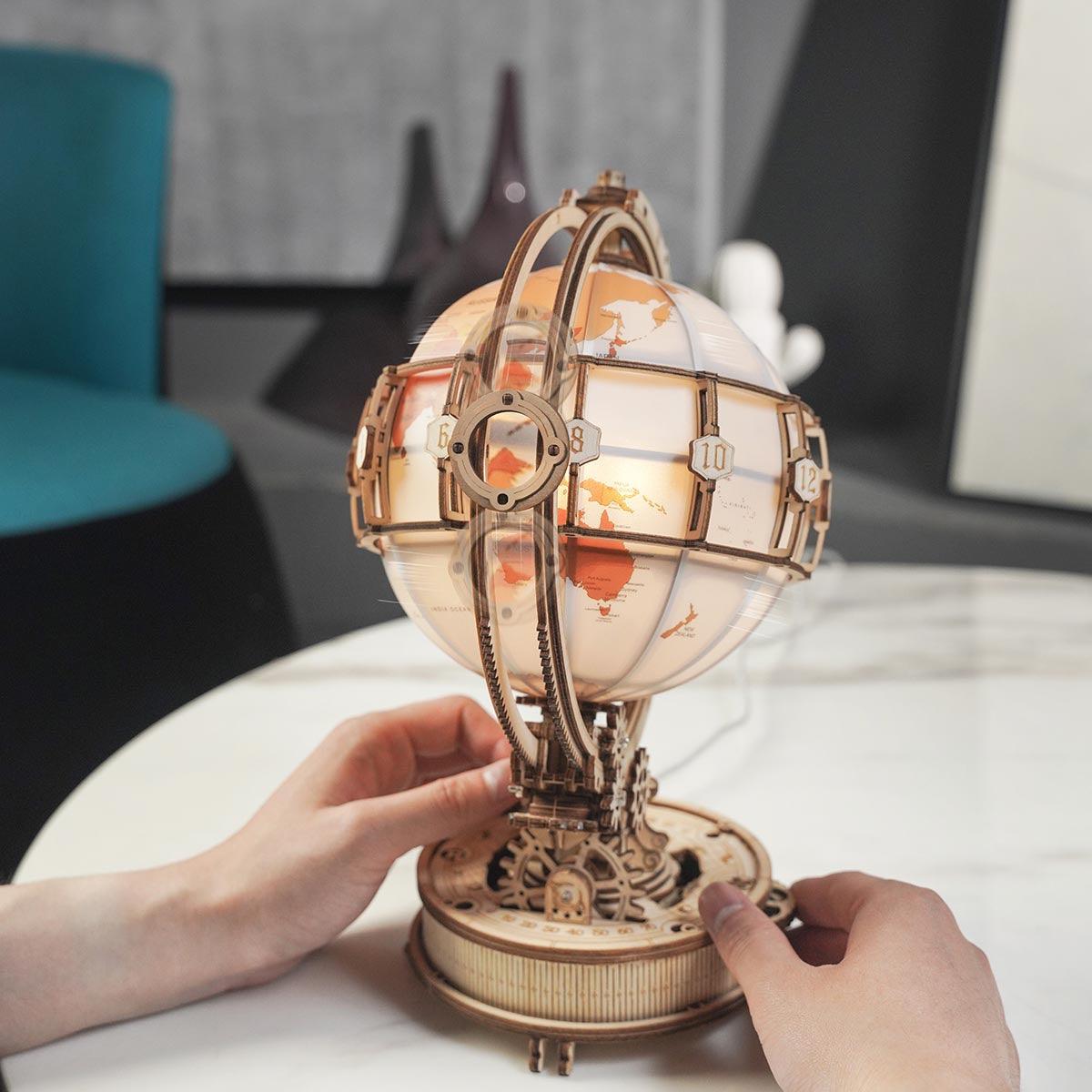 180 laser-cut wooden globe pieces that assemble into a lit world map model, a screen-free building hobby kit for adults