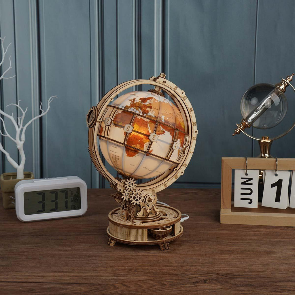 Vintage explorer world globe puzzle with gothic map lettering and warm LED lighting for study shelves and desk decor