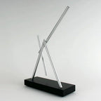 Stress relief kinetic desk toy with mesmerizing swinging motion on a Black base, a calming fidget for focused office work