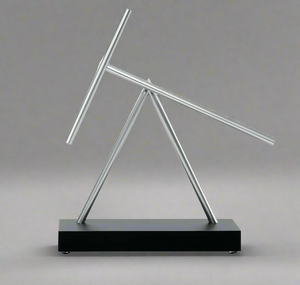 Perpetual motion swinging sticks sculpture driven by a whisper quiet electromagnetic base, a Black kinetic desk toy for offices