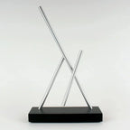 Newton pendulum swinging sticks desk toy from the Pepper Potts Iron Man 2 scene, a Black kinetic sculpture for a home study