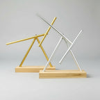 Kinetic swinging sticks sculptures in Gold and Silver finishes on wood bases, collector desk toys with hypnotic motion