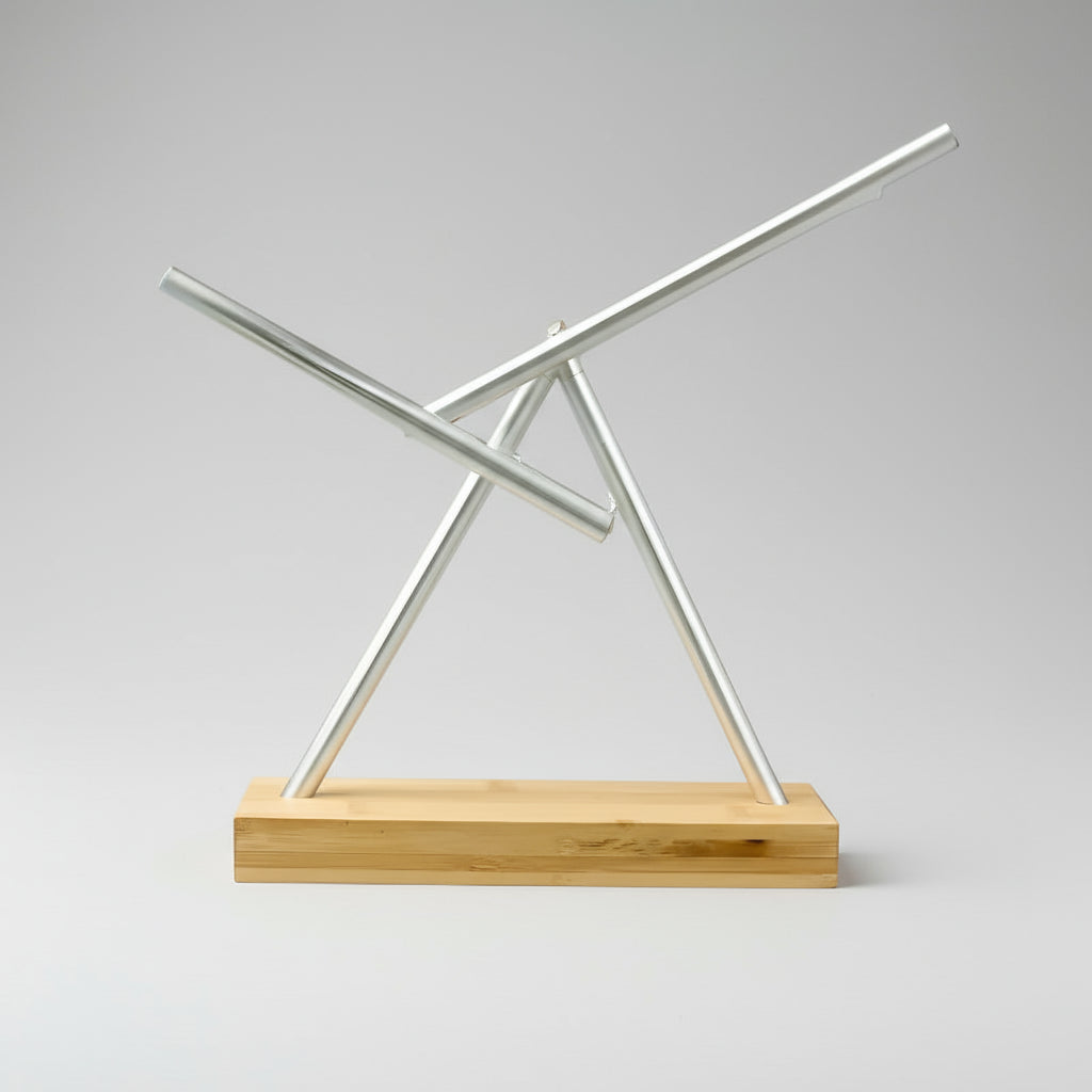 Swinging sticks kinetic sculpture in a Silver finish on a natural wood base, a perpetual motion desk toy for offices