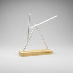 Newton pendulum swinging sticks sculpture with a Silver finish and wood base, engineering desk art for a home office