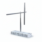Kinetic energy desk sculpture with aluminum arms at rest on a White marble base, executive desk art for a home study