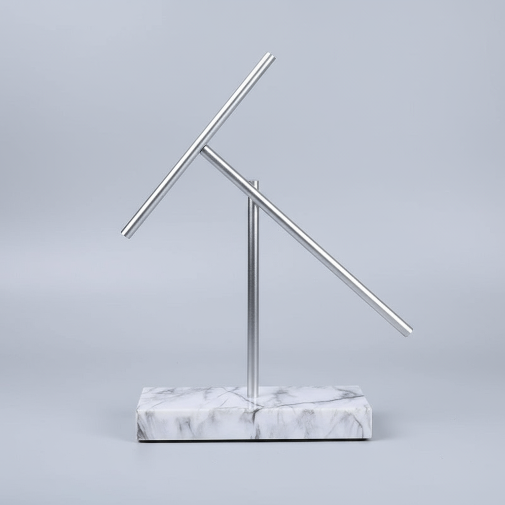 Swinging sticks kinetic sculpture on a White marble base, a perpetual motion desk piece for a modern executive office