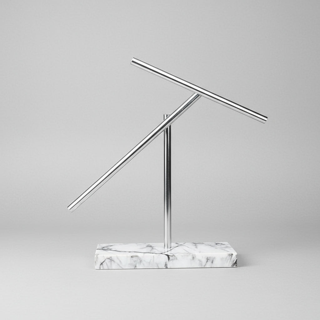 Newton pendulum kinetic sculpture with balanced aluminum arms and a White marble base, a physics gift for engineers