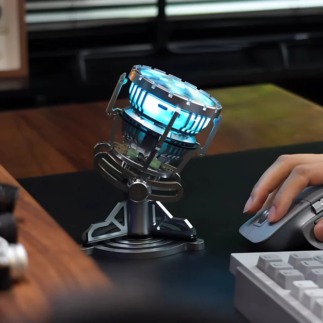 Arc reactor lamp lighting a work desk beside a keyboard and mouse, an Iron Man MK3 collectible and blue LED mood light for fans