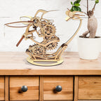 Kinetic wooden hummingbird sculpture with cams and linkages on a sideboard, mechanical model kit for DIY fans