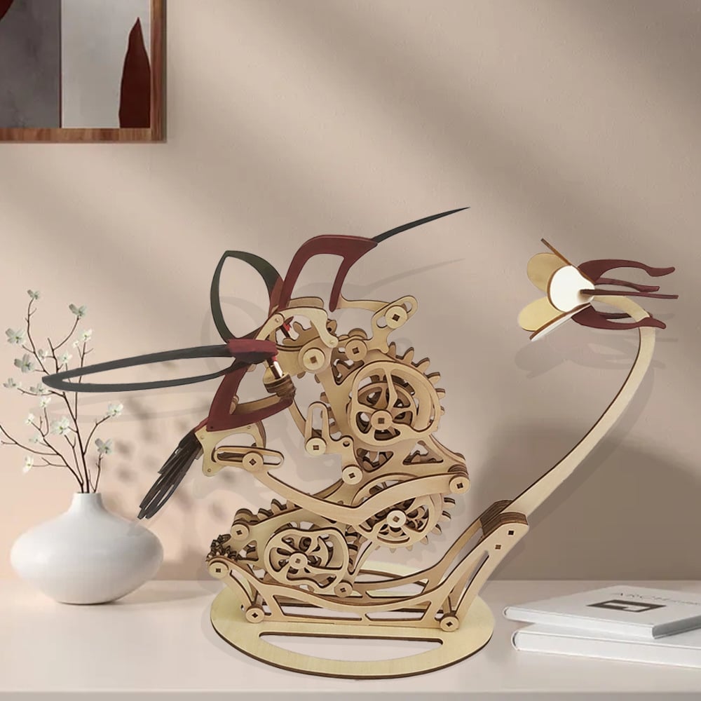 Wooden mechanical hummingbird automaton on a console shelf, kinetic desk sculpture for home and study decor