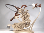 Wooden hummingbird automaton with beating wings in motion, kinetic mechanical model for a home office or study shelf