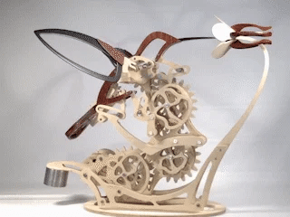 Wooden hummingbird automaton with beating wings in motion, kinetic mechanical model for a home office or study shelf
